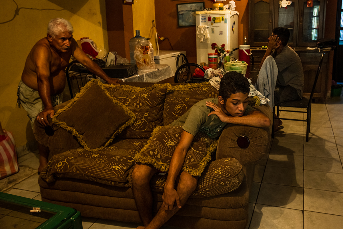 The Raudales family is shown in this May 2014 photo in San Pedro Sula, Honduras. They mourn the loss of two young sons, ages seven and 12, murdered in the same week. Honduras has the world’s highest murder rate, and San Pedro Sula, with a homicide rate of 171 per 100,000 people in 2014, is the world’s most violent city. Photo by Meridith Kohut.